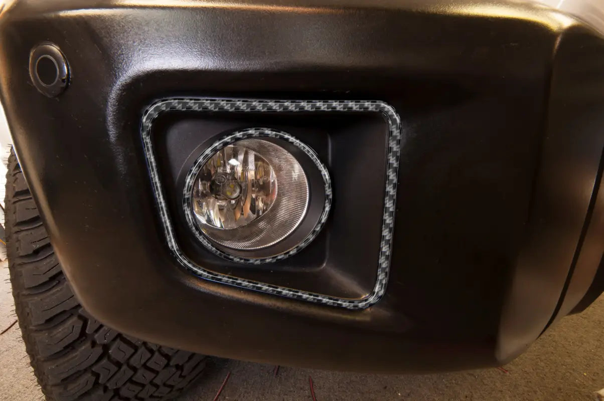 Close-up of carbon fiber-style fog light accent trim fitted on a Toyota Tundra bumper, compatible with 2014-2021 models.