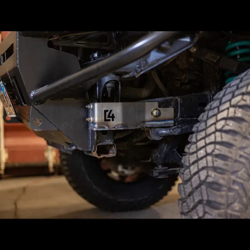 Steel Tacoma front bumper bracket with visible bolts and C4 logo, compatible with 2005-2015 models for enhanced bumper stability.
