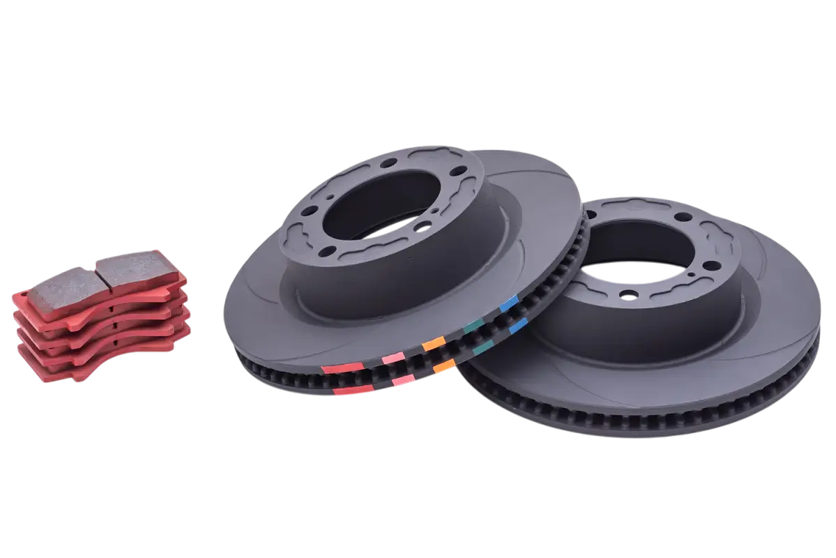 Close-up of GX470 front D-Line rotors and PB05 brake pads, showcasing vented rotors with color-coded edges for enhanced braking performance.