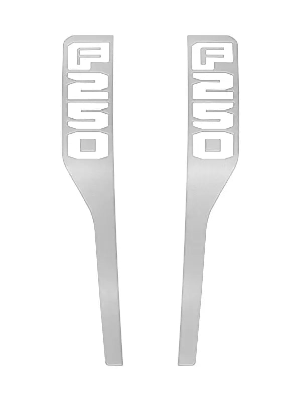 Two silver F250 fender emblem overlays for Ford Super Duty trucks