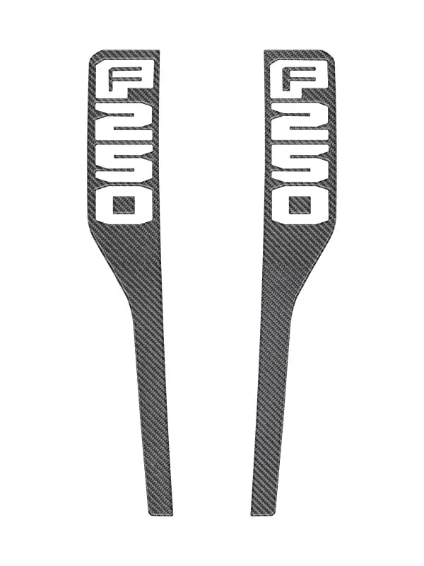 Two carbon fiber door trim pieces for front fender emblem overlays on 2023-2025 Ford Super Duty
