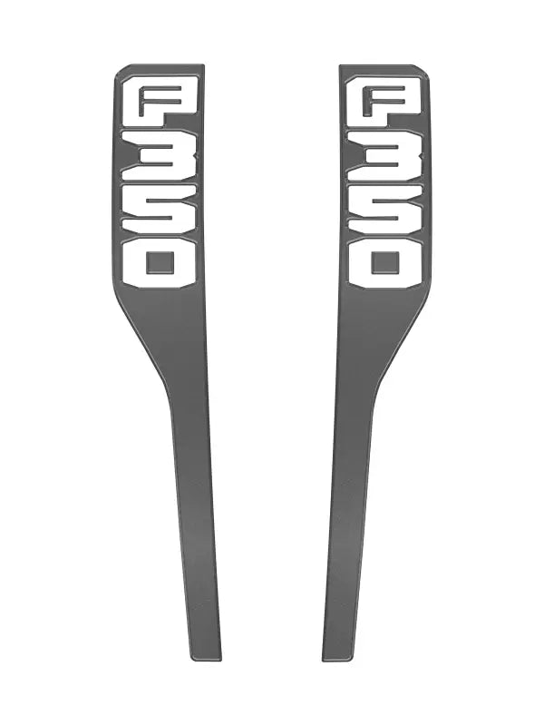Two gray F350 fender emblem overlays for 2023-2025 Ford Super Duty vehicles