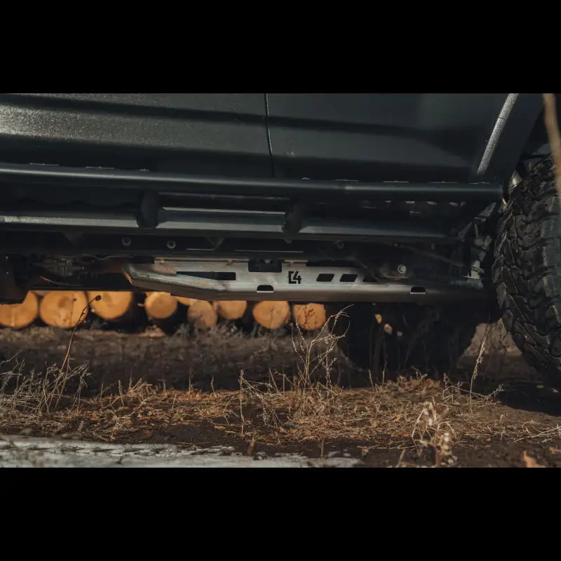 Durable steel skid plate installed on a 5th Gen 4Runner, offering fuel tank protection with bolt-on design and drainage cutouts.