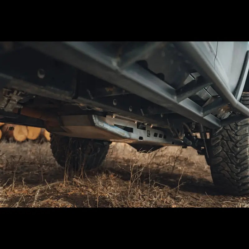 Angled view of GX460 skid plate installed beneath vehicle, emphasizing its durable steel build and hardware-secured fitment.