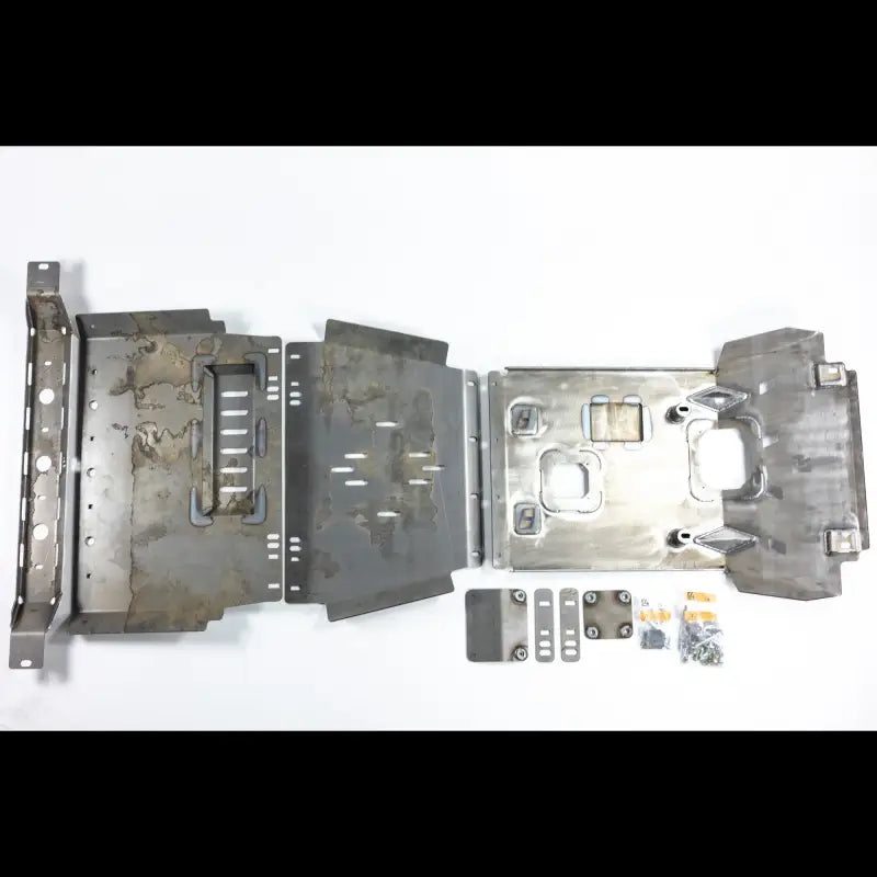Unassembled Tacoma skid plates laid out with hardware, showcasing components for 2nd and 3rd Gen models, 2005+.