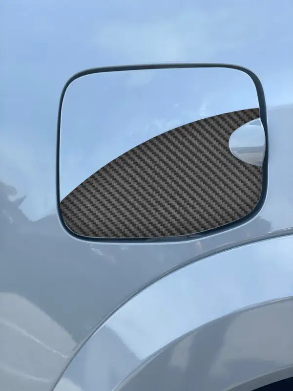 Gas lid protection overlay with carbon fiber texture design, fits 2016-2023 Toyota Tacoma.