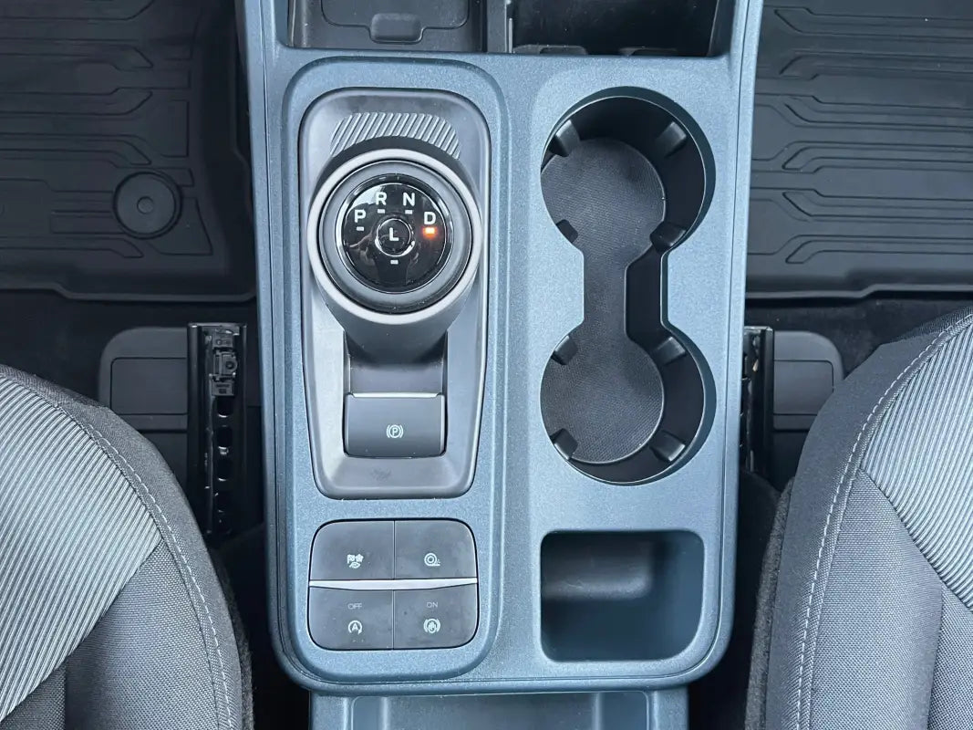 Gear selector accent overlay on Ford Maverick center console with gear selector and cupholders