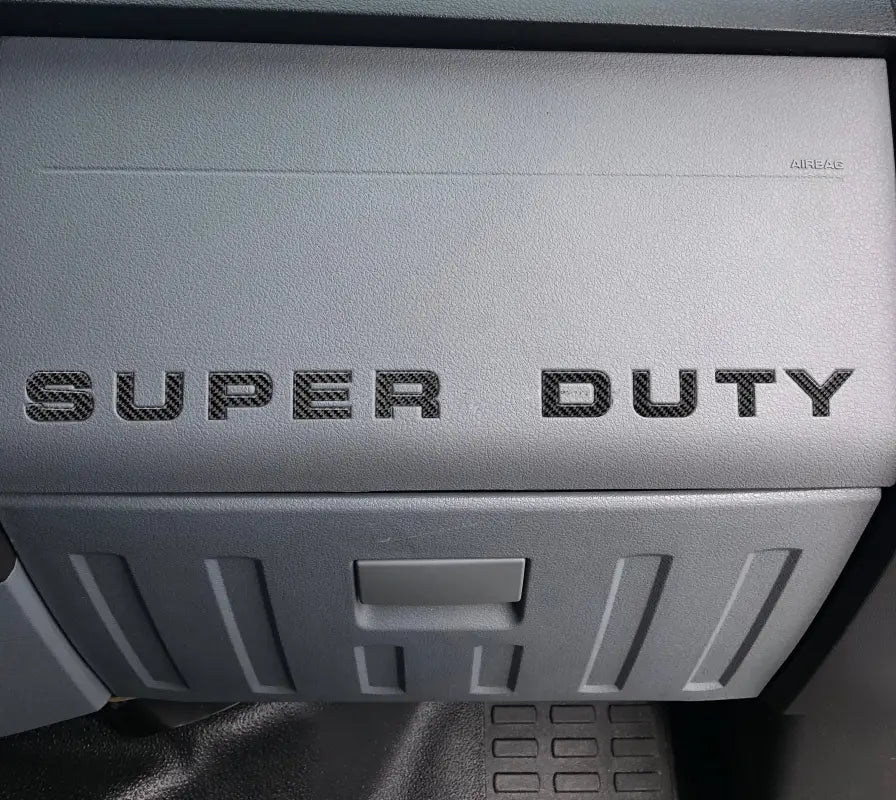 Gray dashboard with Super Duty lettering showing glove box letter insert for Ford Super Duty