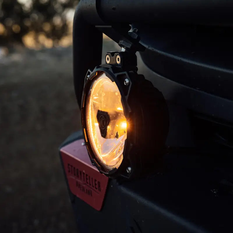 Mercedes Sprinter van with Gravity Titan 6-inch LED lights mounted on the roof and bumper for off-road adventures.