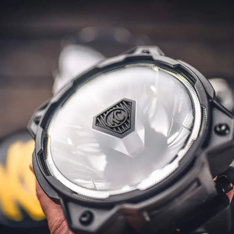 Close-up of Gravity Titan 6-inch LED light with clear lens, showcasing KC logo and durable design for off-road applications.