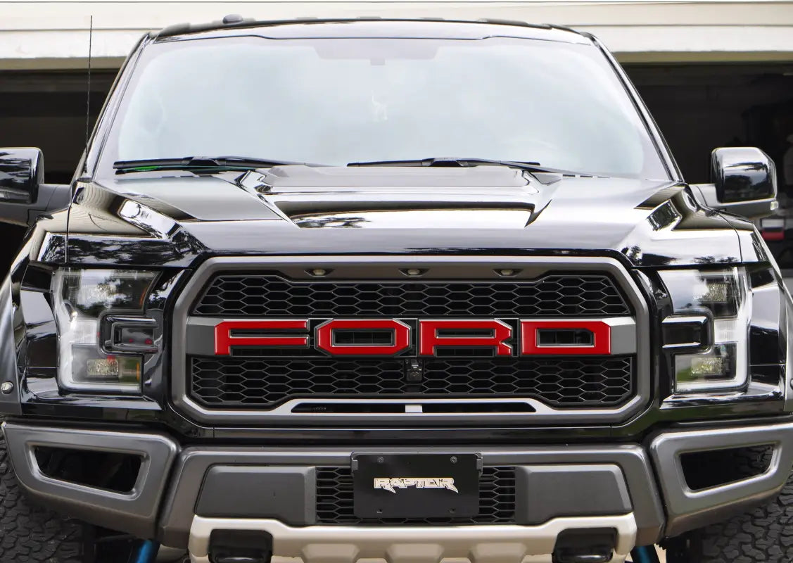 Black Ford Raptor truck with grille letter overlays for 2015-2020 Ford F-150 Raptor