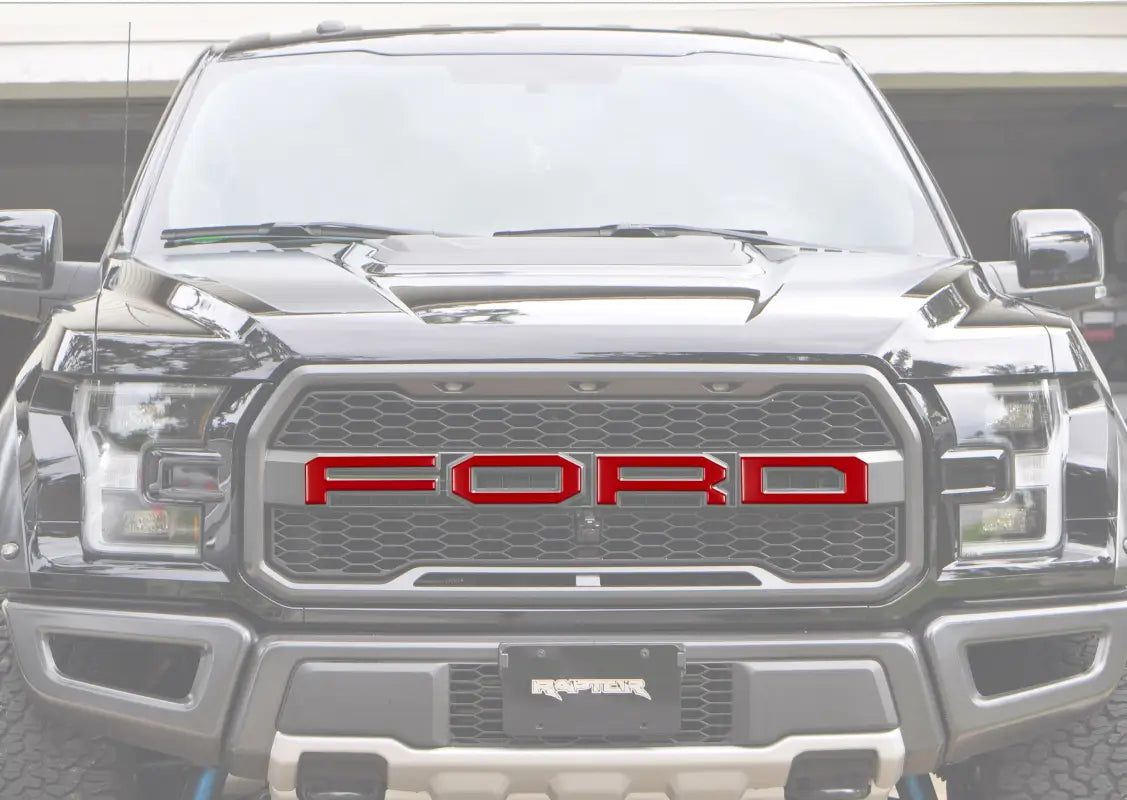 Black Ford Raptor truck with grille letter overlays for 2015-2020 Ford F-150 Raptor