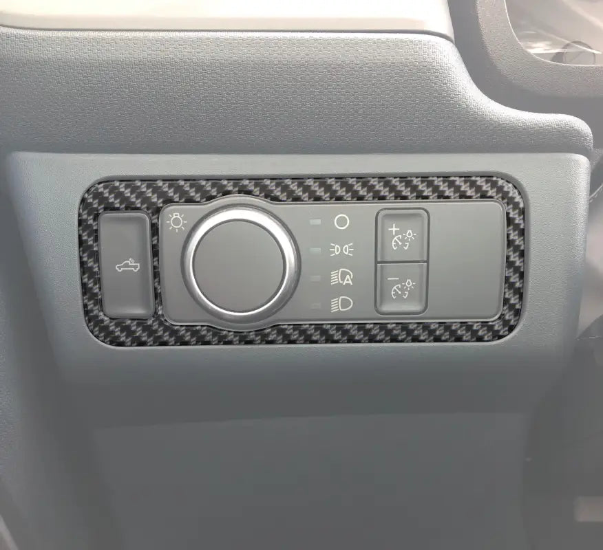 Car light control panel with carbon fiber trim showing headlight switch accent overlay for Ford Maverick