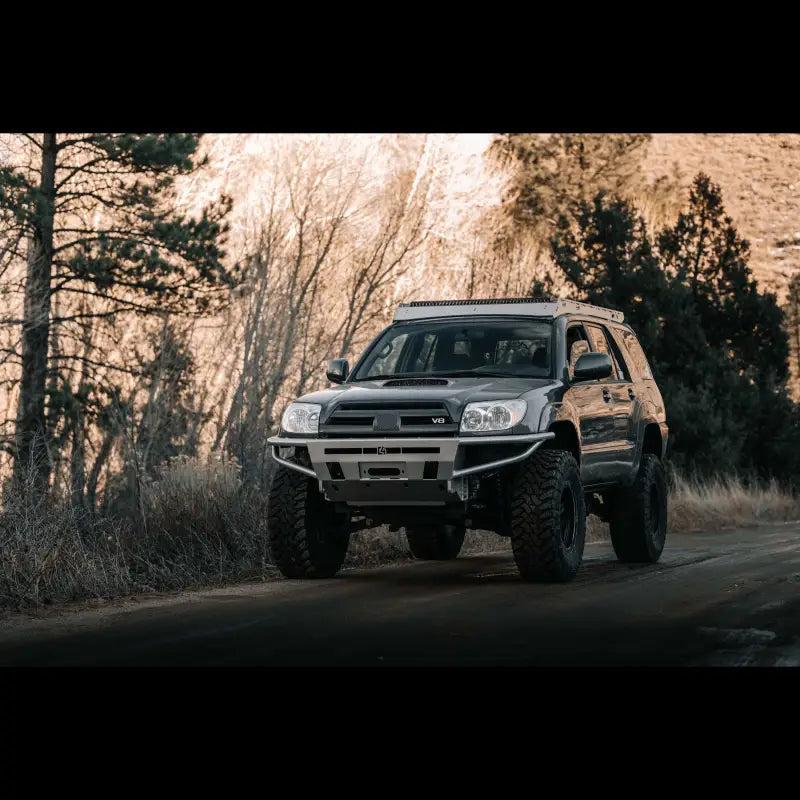 Side angle of a 4Runner Hybrid Bumper installed on a lifted 2003-2009 4Runner, emphasizing off-road capability and robust design.