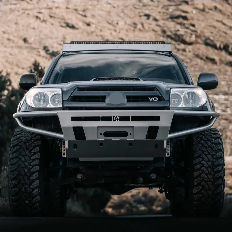 Front view of a 4Runner Hybrid Bumper for 2003-2009 models, featuring a winch mount, LED compatibility, and rugged design for off-road use.