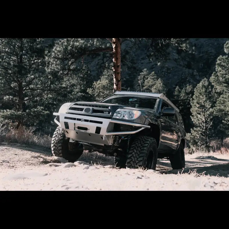 4Runner Hybrid Bumper on a 2003-2009 4Runner in an off-road setting, highlighting its rugged build and winch mount compatibility.