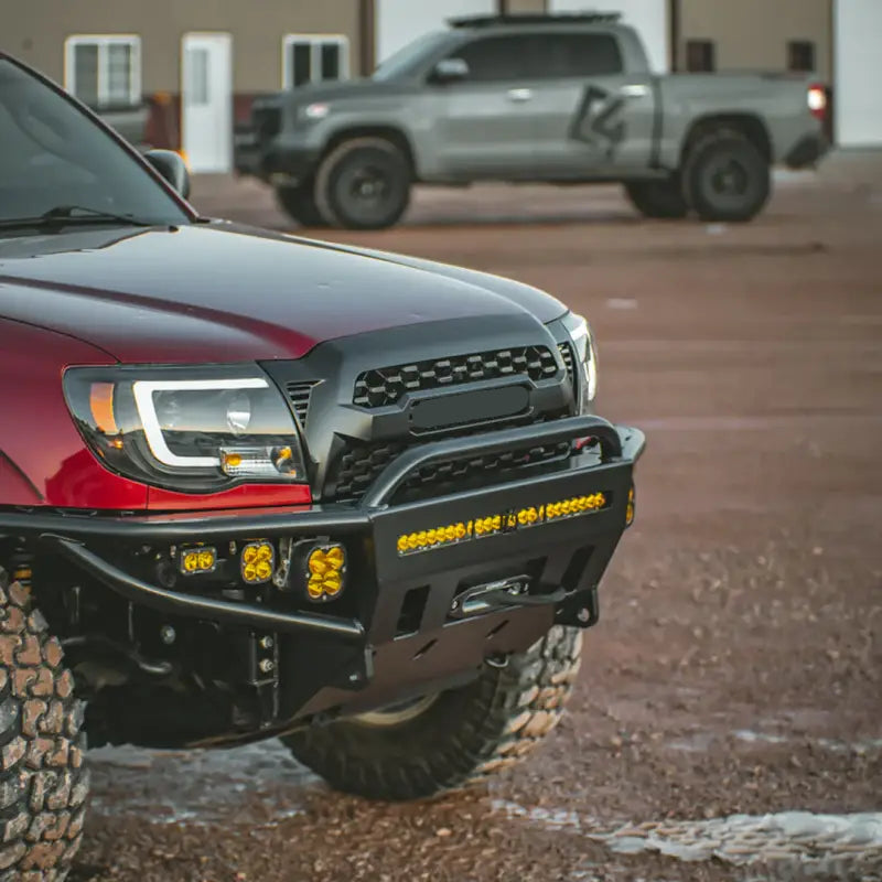 2nd Gen Tacoma with hybrid front bumper featuring bolt-on design, winch compatibility, and integrated 30-inch light bar, parked outdoors.