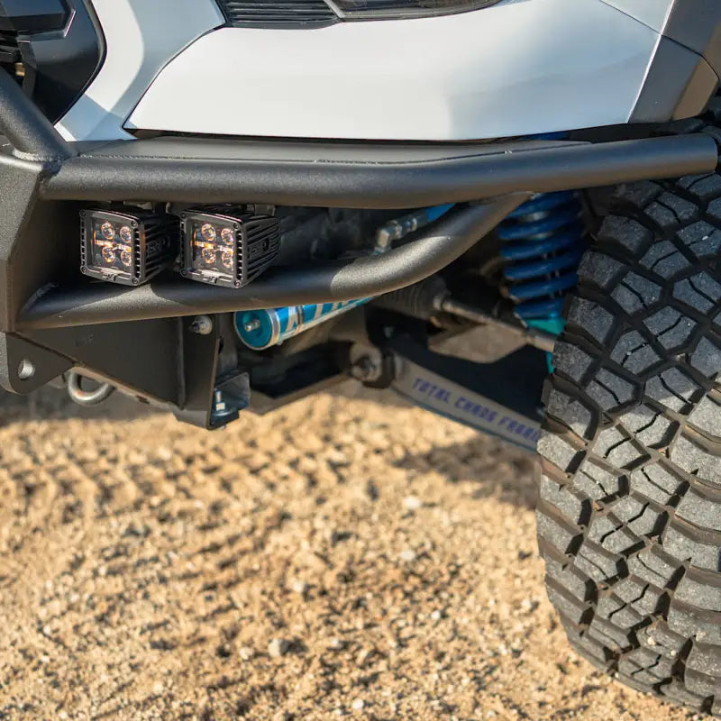 Detailed view of the lower section of a 3rd Gen Tacoma hybrid front bumper, highlighting steel construction, fog lights, and suspension components.