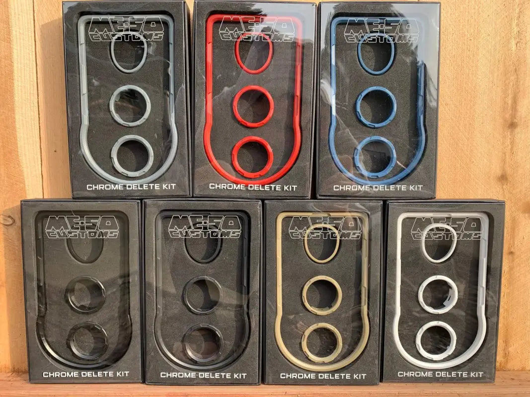 Assorted chrome delete kits for Toyota Tacoma 2016-2023 in various colors, packaged in branded boxes for easy installation.