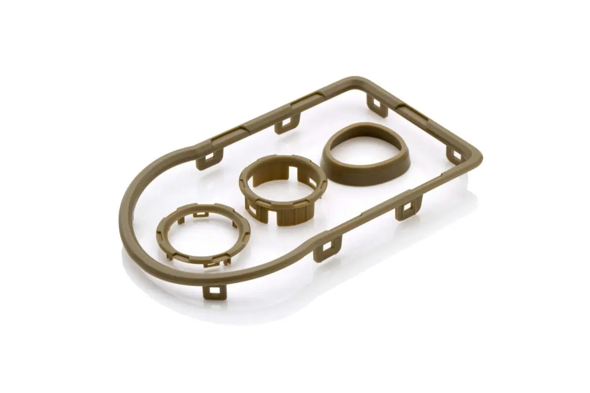 Tan-colored chrome delete kit for Toyota Tacoma 2016-2023, designed for dashboard and control customization.