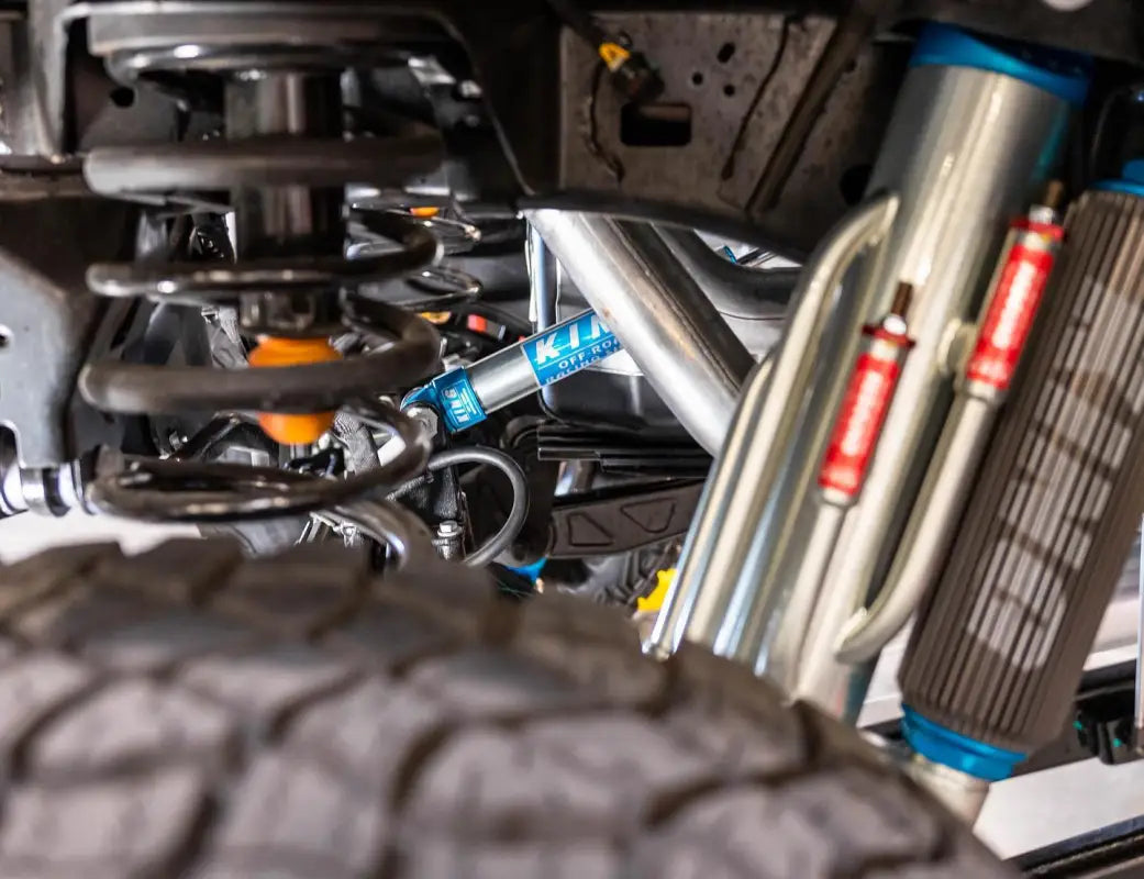 Installed King 2.0 rear axle shock on a 2021-2023 Ram 1500 TRX, highlighting suspension setup with coil springs and off-road components.