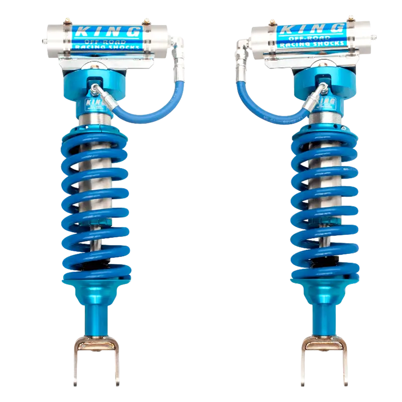 Adjustable 2.5-inch Ram 1500 Coilover Kit with blue springs and remote reservoirs, designed for improved handling and off-road capability.