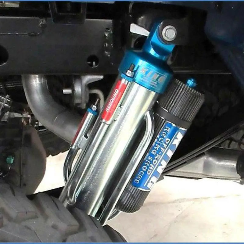 Installed 17-23 Ford Raptor 3.0 4-tube rear bypass shock showcasing adjustable suspension and heat dissipation design.