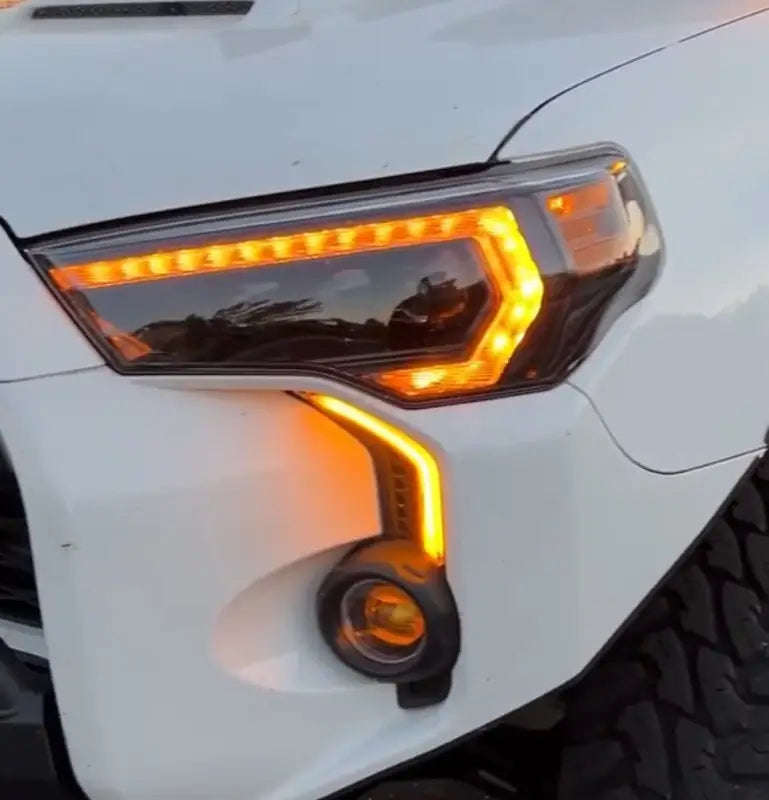 Close-up of Toyota 4Runner headlight featuring LED DRL Fang Light Bezel Kit in amber, highlighting the upgraded design and functionality.
