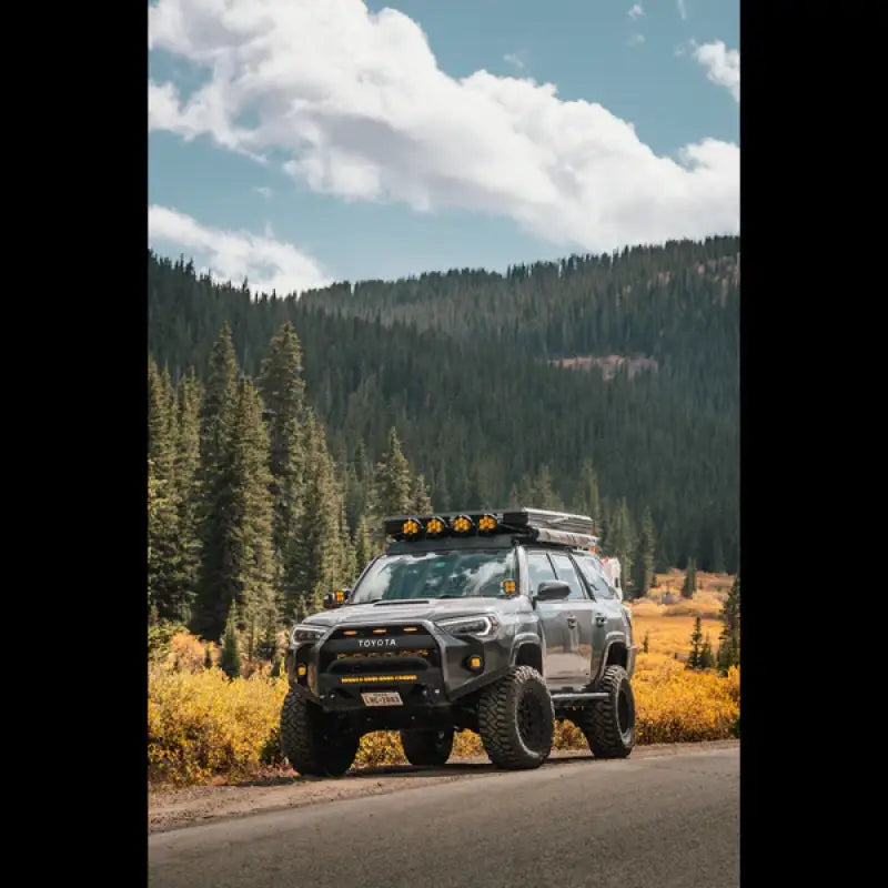 Toyota 4Runner with Lo Pro Bumper High Clearance Additions on a mountain road, emphasizing rugged design and high clearance.