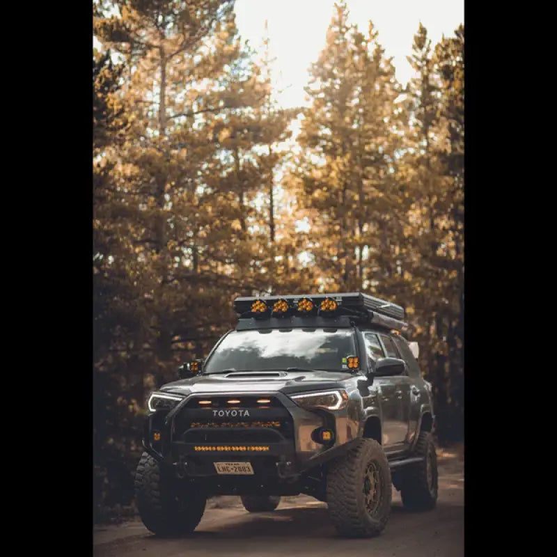 Toyota 4Runner with Lo Pro Bumper High Clearance Additions in a forest setting, highlighting off-road capability and bolt-on installation.