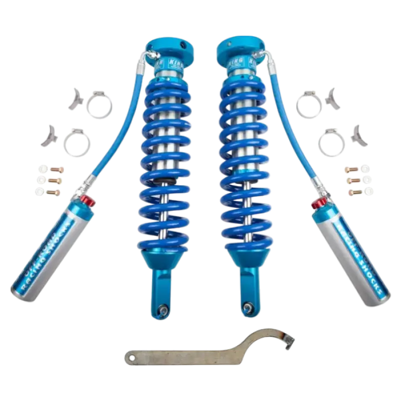 King coilovers for 2005-2023 Toyota Tacoma with Total Chaos Kit. Blue shocks with compression adjuster, extended axles, and mounting hardware.