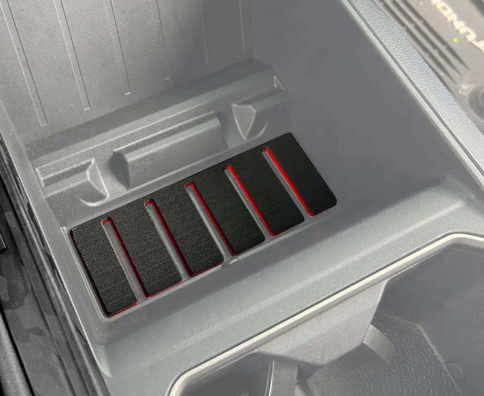 Lower center console foam inserts with red accents installed in a 2022-2024 Toyota Tundra or 2023-2024 Toyota Sequoia, enhancing interior decor.