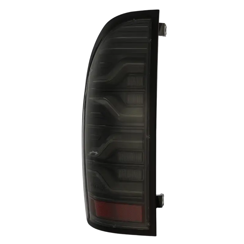 Side view of LUXX-Series LED tail light for Toyota Tacoma, showcasing its smoked black design and durable build.