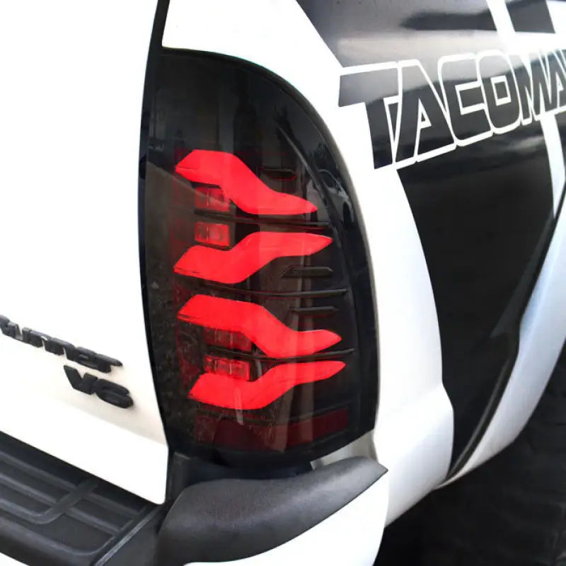 LUXX-Series LED tail light installed on a Toyota Tacoma, showcasing its modern red illumination and stylish fit.