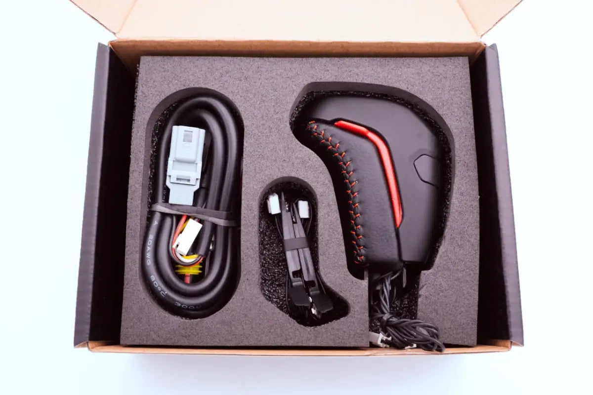 Meso Stealth Shift Knob kit for 16-23 Tacoma in packaging, including wiring and components for easy installation.