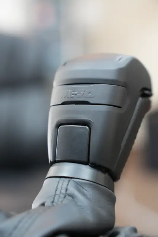 Close-up of Meso Stealth Shift Knob installed on a 16-23 Tacoma, highlighting its ergonomic design and button placement.