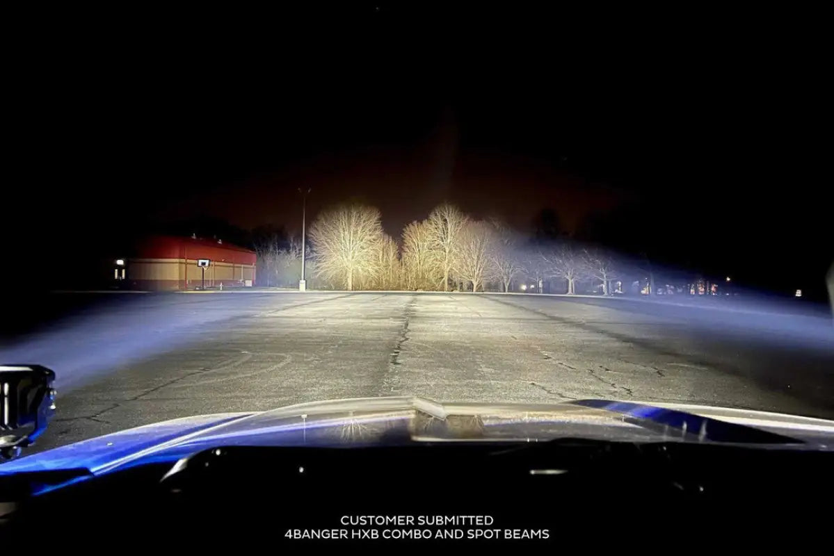 Nighttime view of Morimoto HXB 4Banger Ditch Lights with combo and spot beams, illuminating a wide area for off-road visibility.