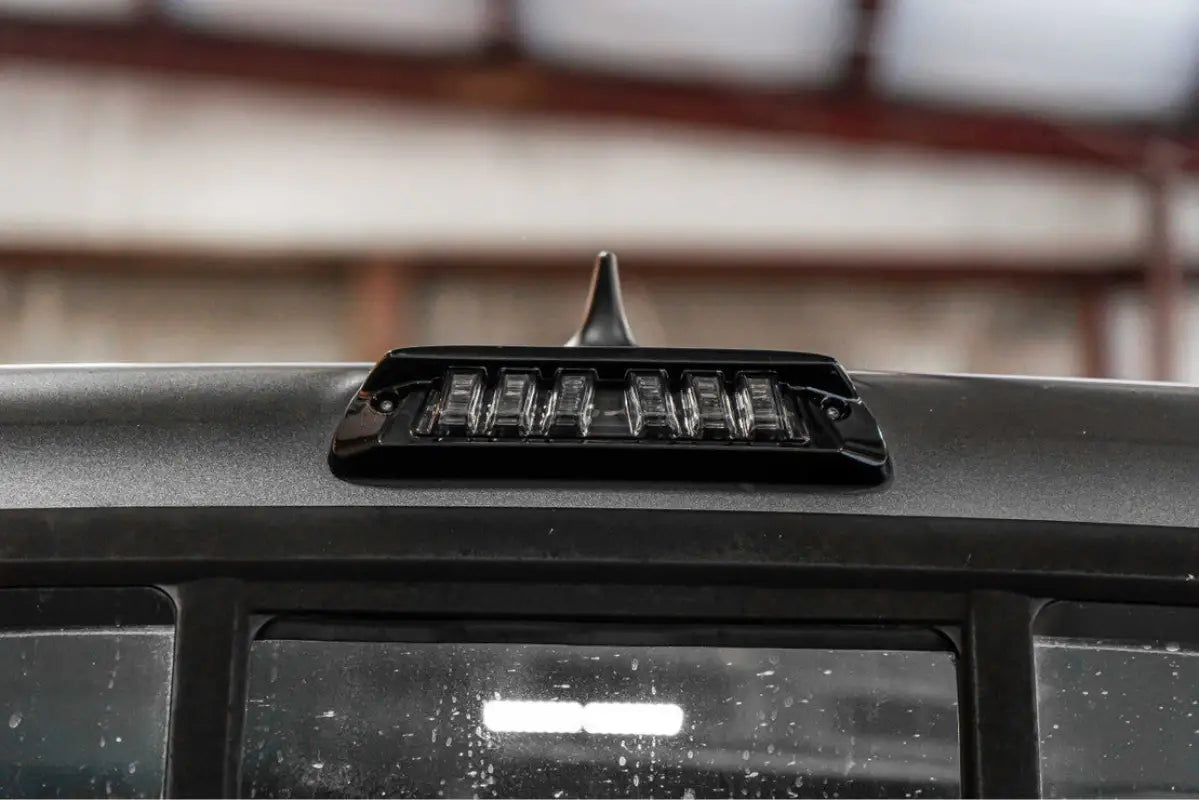 Morimoto X3B LED third brake light with clear lens installed on a Tacoma Access Cab (2005-2023), showcasing a seamless OEM fit.