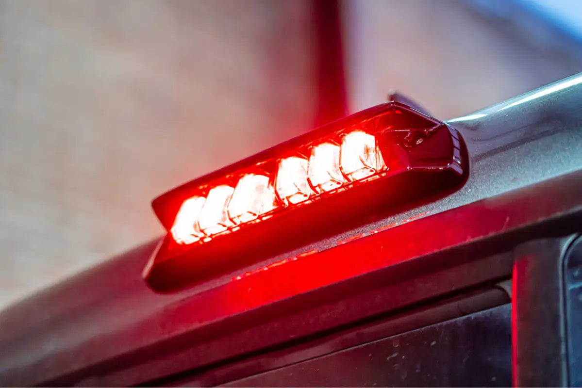Morimoto X3B LED third brake light with bright red illumination installed on a Tacoma Access Cab (2005-2023), highlighting its modern design.