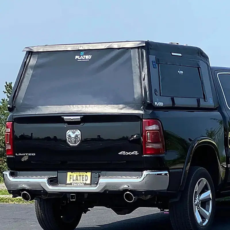 Black truck with MR Full-Size 5.5' Bed air-topper shell installed, featuring tinted rear windows and a sleek design.