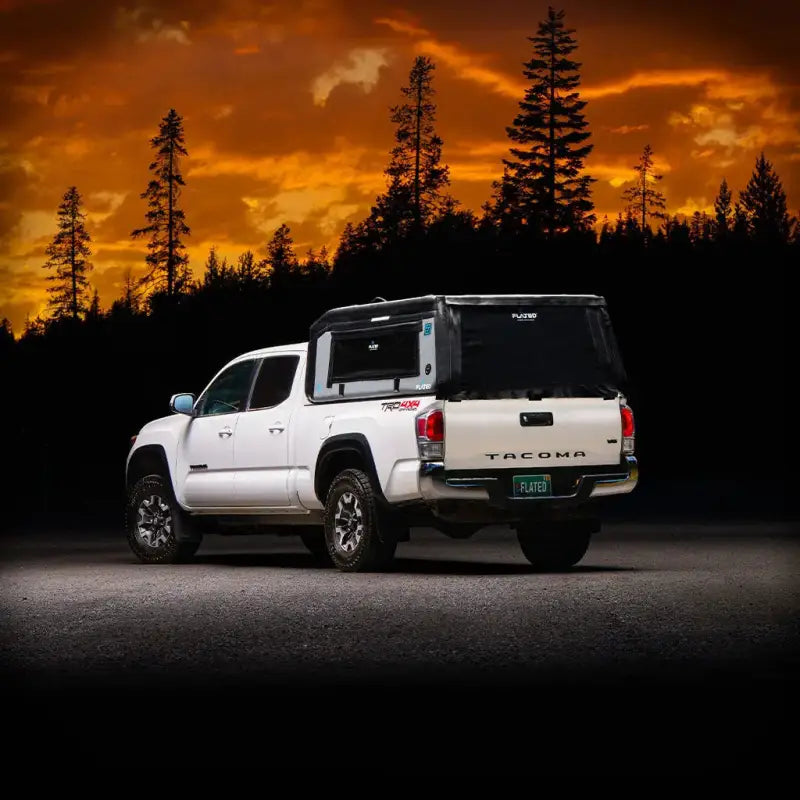 MR - Mid-Size 6'-Long Bed inflatable truck shell fitted on a white Tacoma truck at sunset, emphasizing its compatibility and outdoor utility.