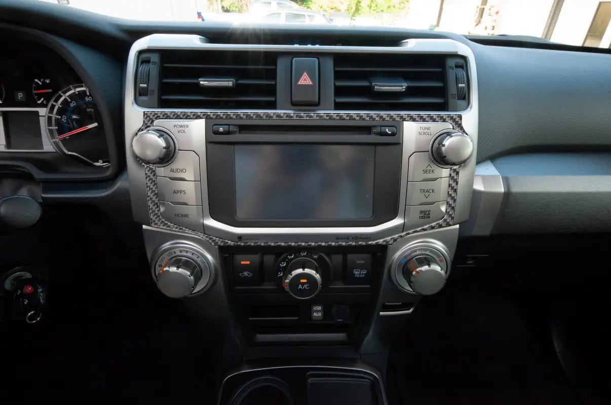 Close-up of a carbon fiber-style Navigation/CD Player Outer Radio Display Accent fitted on a Toyota 4Runner dashboard, compatible with 2014-2024 models.