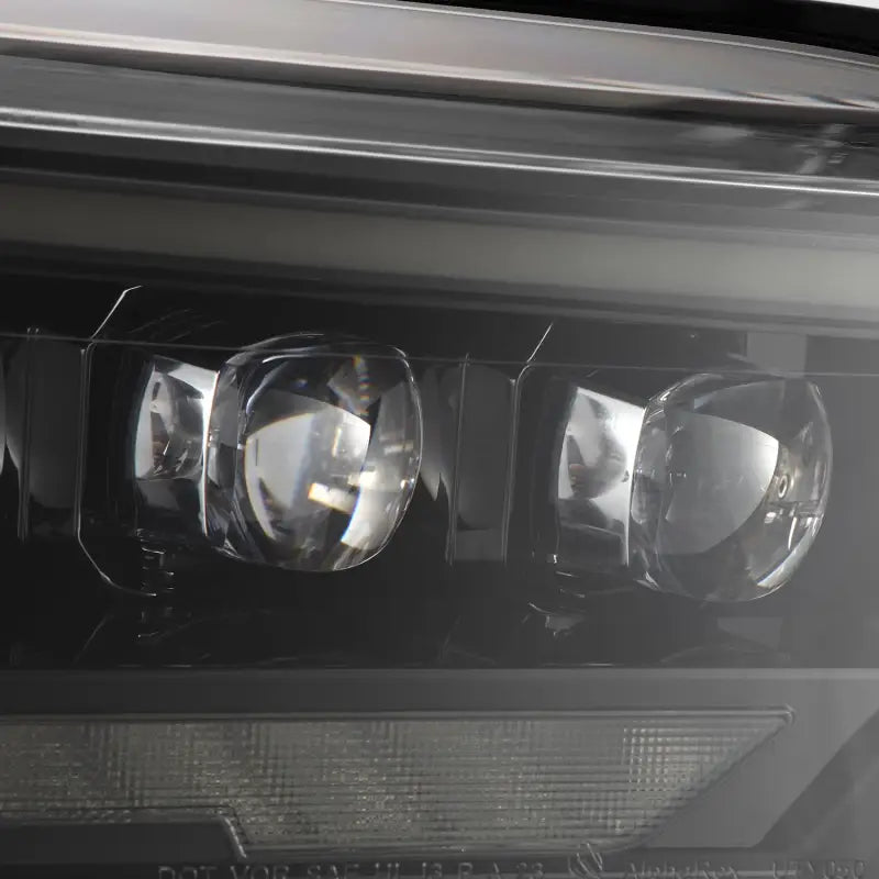 Detailed view of the LED projector lenses on AlphaRex NOVA-Series headlights, designed for 22-24 Toyota Tundra and Sequoia.