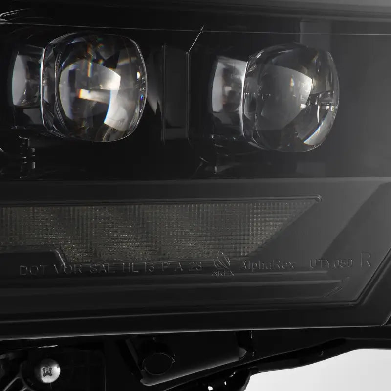 Close-up of AlphaRex NOVA-Series LED projector headlight lens, highlighting the precision optics for enhanced lighting performance.