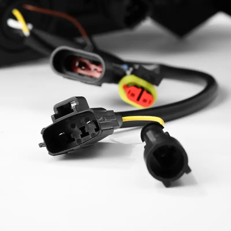 Close-up of wiring connectors for AlphaRex NOVA-Series LED projector headlights, highlighting plug-and-play installation compatibility.