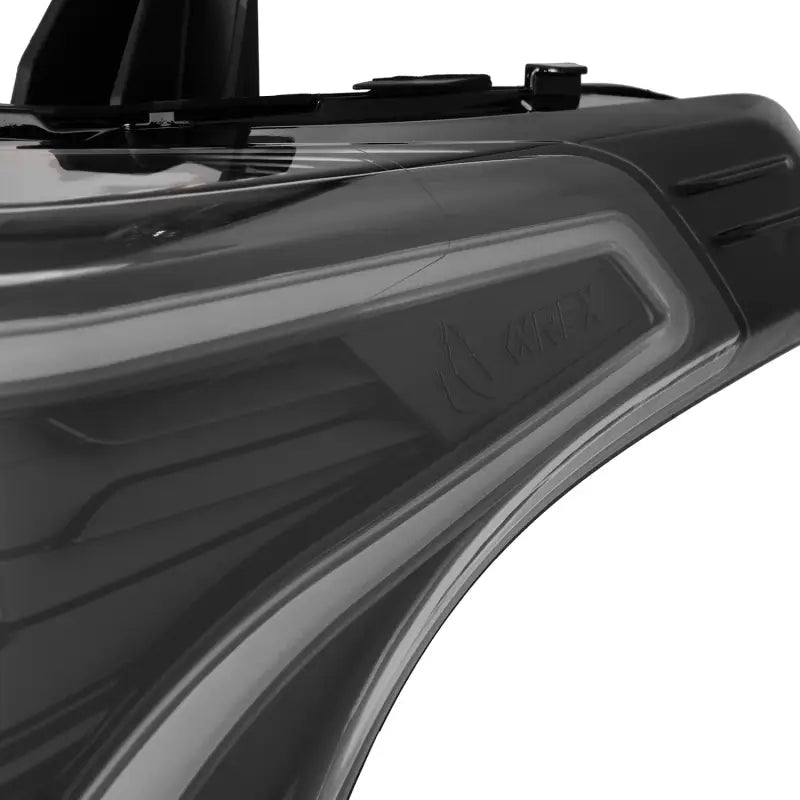 Close-up of the AlphaRex logo and textured design on the housing of NOVA-Series LED projector headlights, showcasing premium craftsmanship.