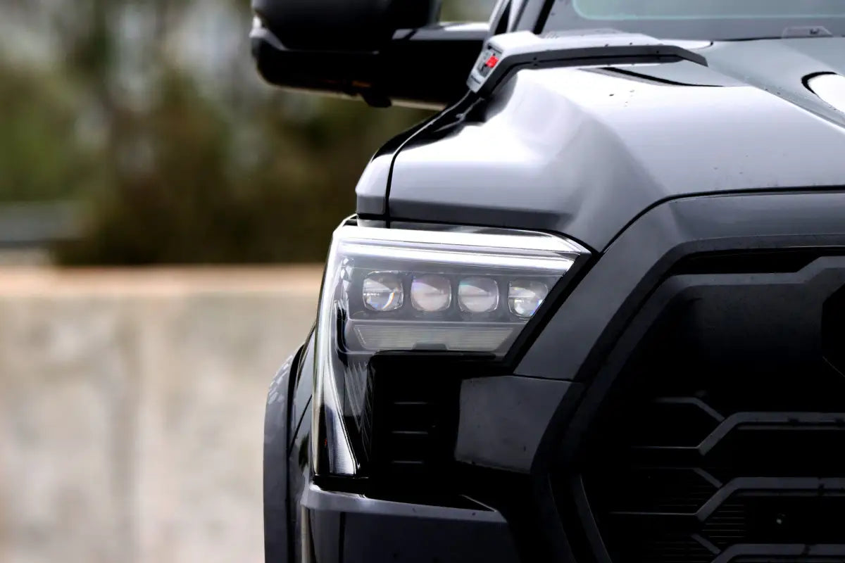Close-up of AlphaRex NOVA-Series LED projector headlights installed on a Toyota Tundra, showcasing detailed craftsmanship and sleek aesthetics.