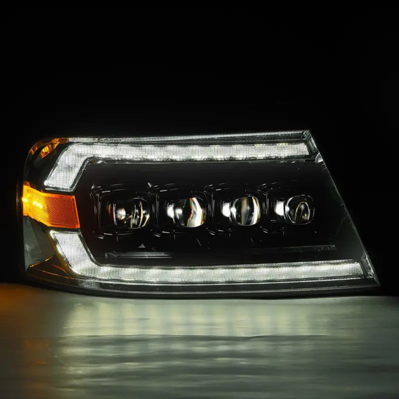 Ford F150 04-08 LED projector headlight in black housing illuminated with white LED DRL and quad projectors.