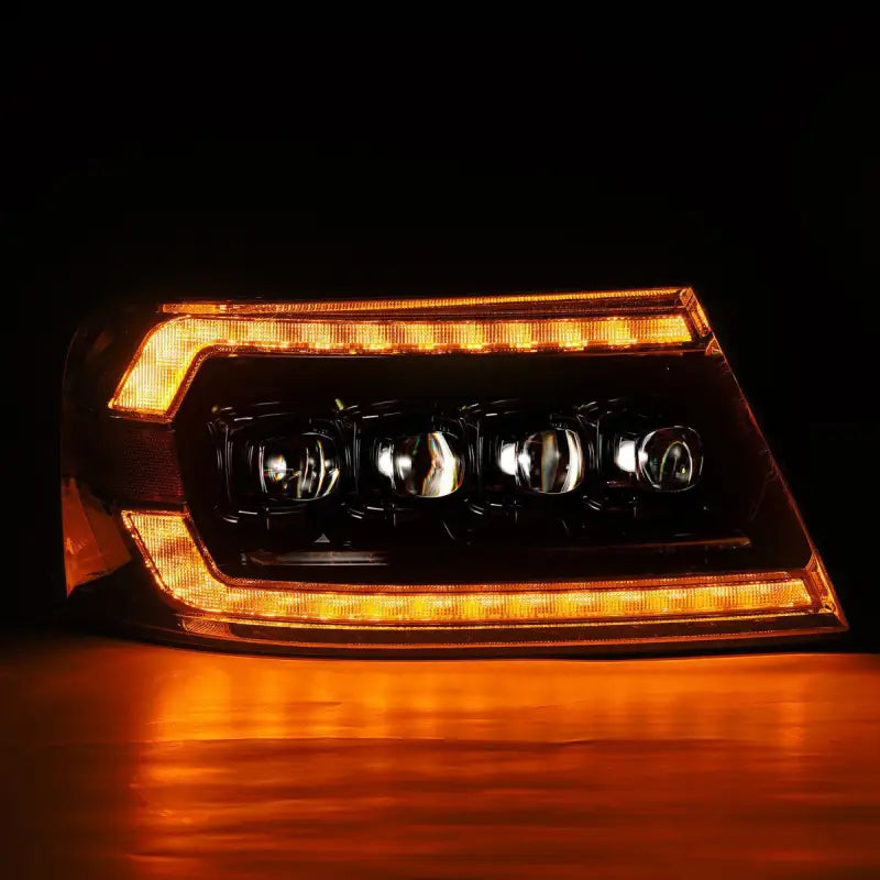 Ford F150 04-08 LED projector headlight in black housing illuminated with amber sequential turn signal lighting.