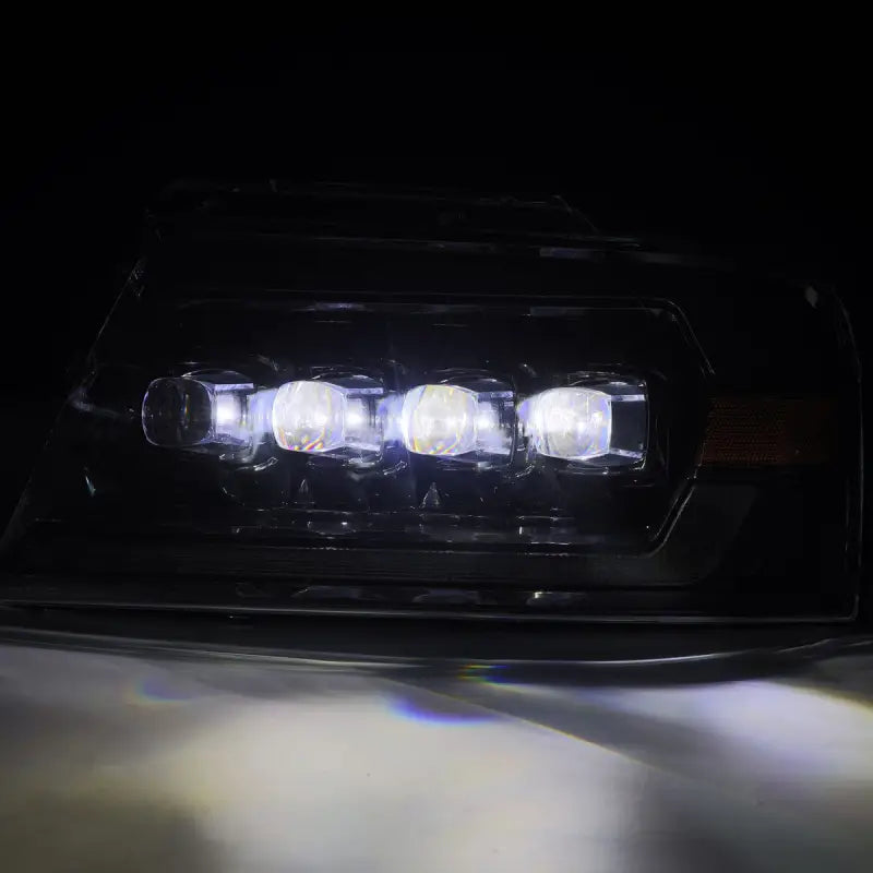 Detailed view of Ford F150 04-08 LED projector headlights in black housing showcasing bright LED lighting.